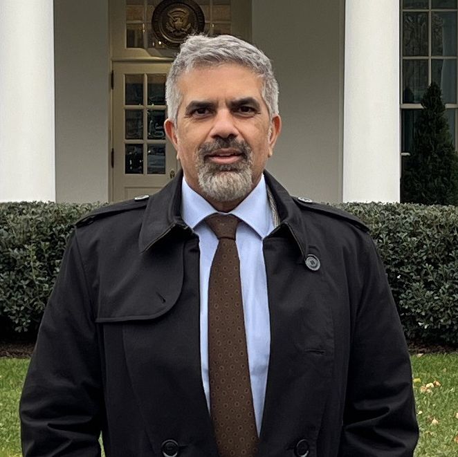 Chan Harjivan standing outdoors in front of building